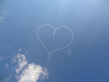 Low angle view of heart shape against sky