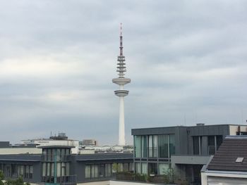 Cityscape against cloudy sky