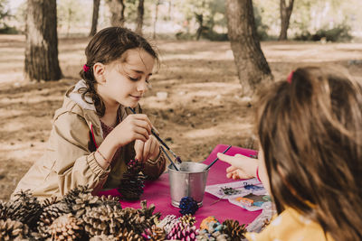 Rear view of women sitting on street