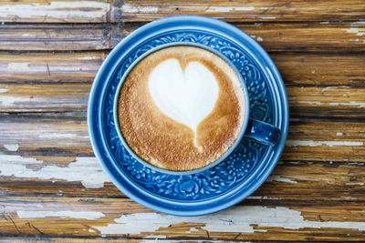 Directly above shot of cappuccino served on table