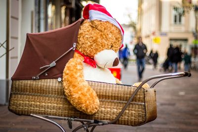 Teddy bear in baby carriage