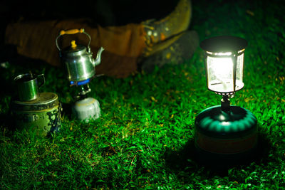 Close-up of illuminated lamp on table