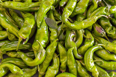 Full frame shot of green chili peppers for sale in market