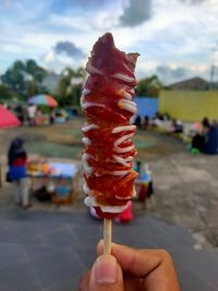 Cropped hand holding ice cream cone