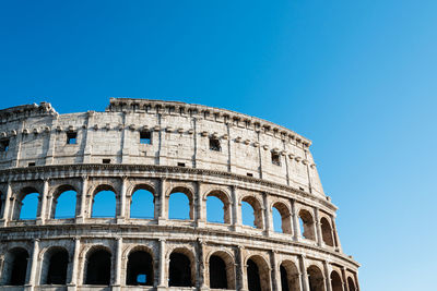 Low angle view of historical building against clear blue sky