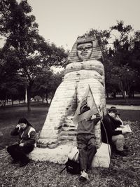 Men sitting on grass