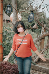 Portrait of woman wearing mask standing outdoors