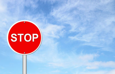 Low angle view of road sign against sky