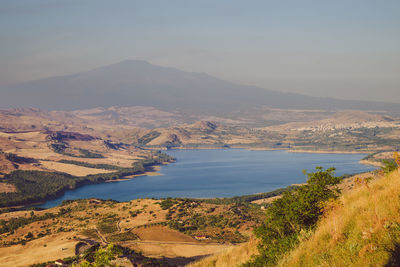 Scenic view of lake and mountains against sky