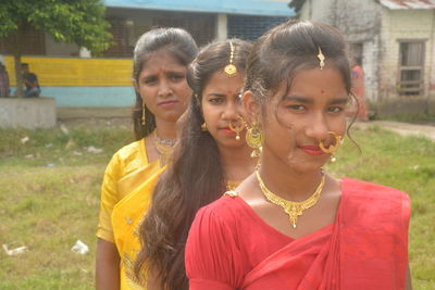 Portrait of smiling women standing outdoors