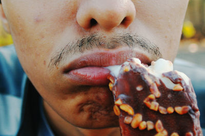 Close-up of man eating ice cream