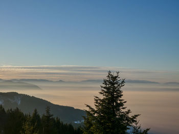 Scenic view of mountains against clear sky at sunset