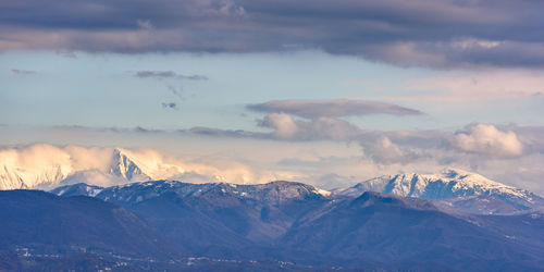 Scenic view of snowcapped mountains against sky