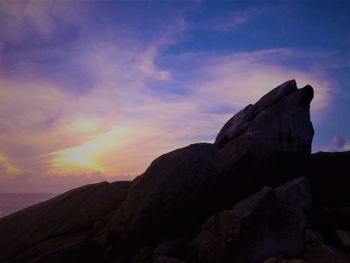 Rock formation against sky during sunset