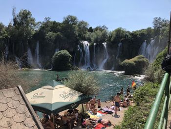 Panoramic view of waterfall by trees