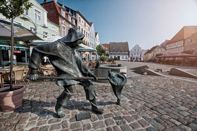 View of statues on street in city