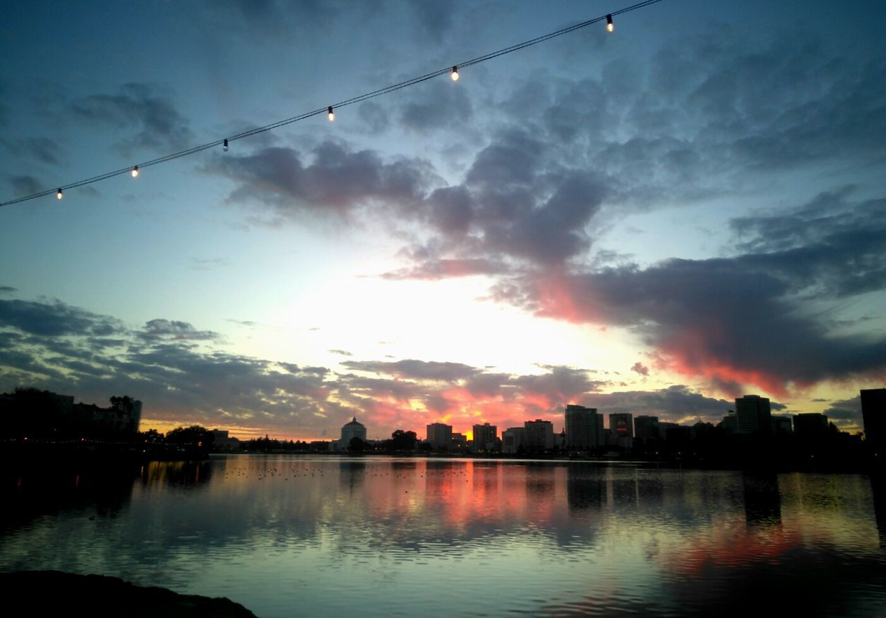 SCENIC VIEW OF RIVER BY SILHOUETTE CITY AGAINST SKY