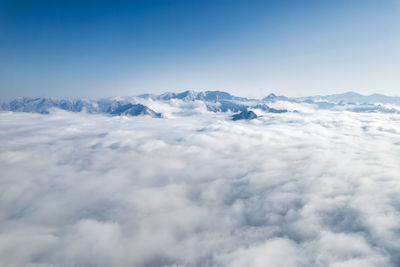 Aerial view of snowcapped mountains against sky