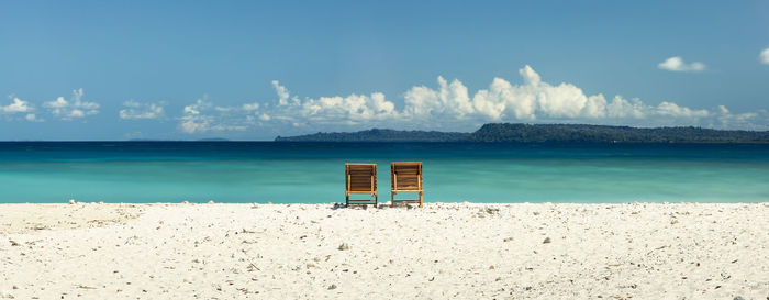 Two sunbed chairs at the turquoise coast of tropical paradise  neil island in andaman islands, india
