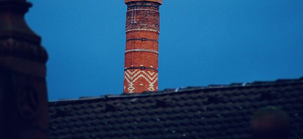 Low angle view of tower of building against blue sky