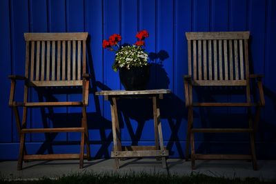 Empty chairs and tables against blue wall