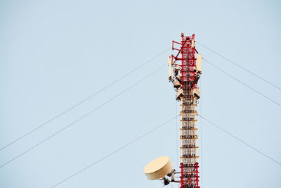 Low angle view of communications tower against sky