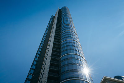 Low angle view of modern building against clear blue sky