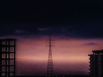 Low angle view of silhouette buildings against dramatic sky