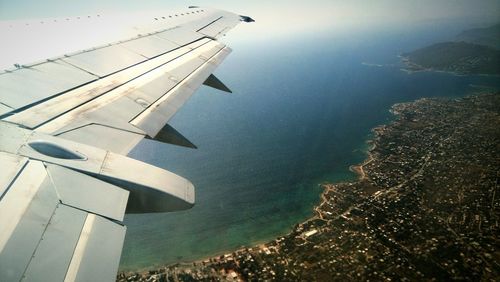 Cropped image of airplane flying over sea
