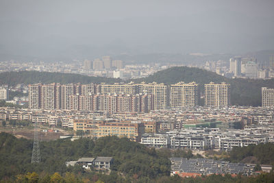 High angle view of buildings in city against sky