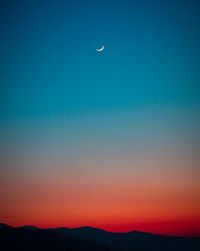 Scenic view of moon against blue sky