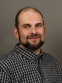 Portrait of bearded man against gray background