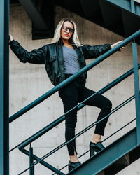 Low angle view of fashionable woman standing on staircase