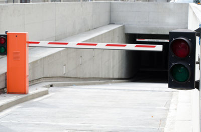 Barricade and stoplight over road leading towards parking garage