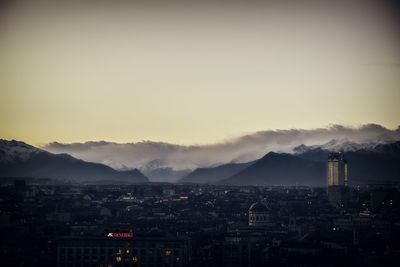 Smoke emitting from chimney against sky in city