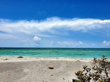 Beach, turquoise water and white clouds