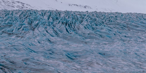 Full frame view of rugged blue glacier ice