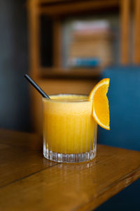 Close-up of orange juice on wooden table