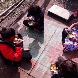 High angle view of people photographing food