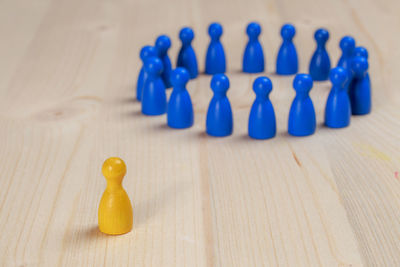 High angle view of pawns arranged on wooden table