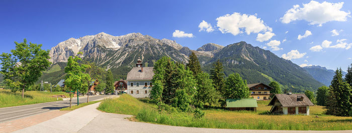 Panoramic shot of building and mountains against sky