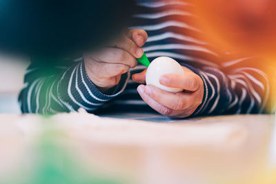 Young boy coloring an easter egg