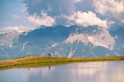 Scenic view of lake and mountains against sky