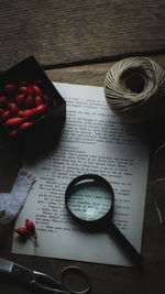 High angle view of magnifying glass on table