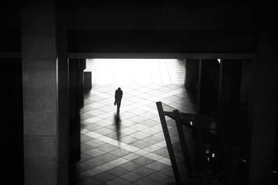 Silhouette of person standing at entrance of building