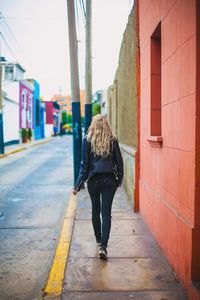 Rear view of man walking on road