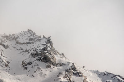 Scenic view of snow covered mountains against sky