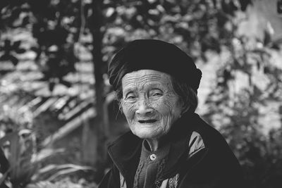 Portrait of senior woman against trees