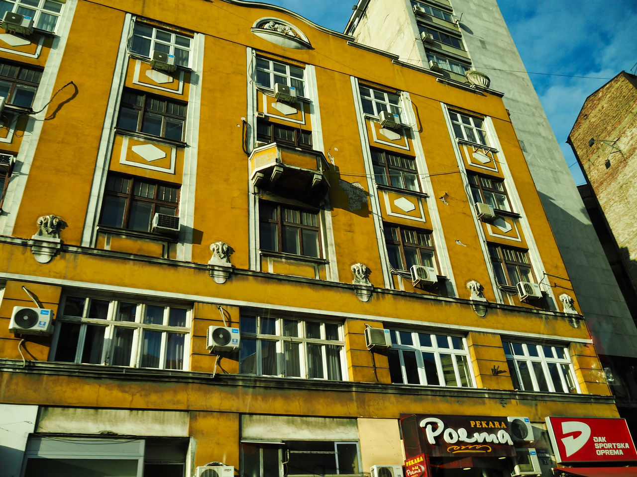 LOW ANGLE VIEW OF YELLOW BUILDING