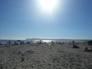 Scenic view of beach against blue sky